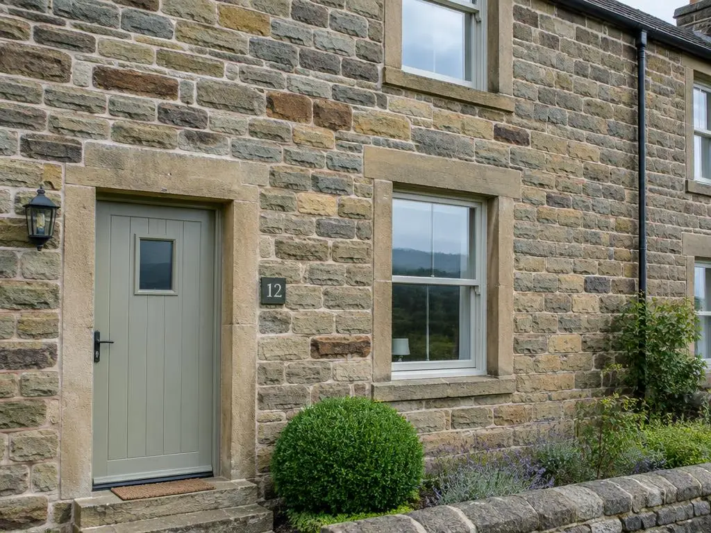 Stone Masonry in Yorkshire Stone-built Yorkshire cottage with neatly pointed sandstone walls and dressed window surrounds